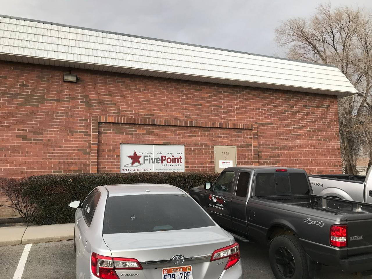 Five Point Restoration brick office building exterior with company sign and address visible at 1376